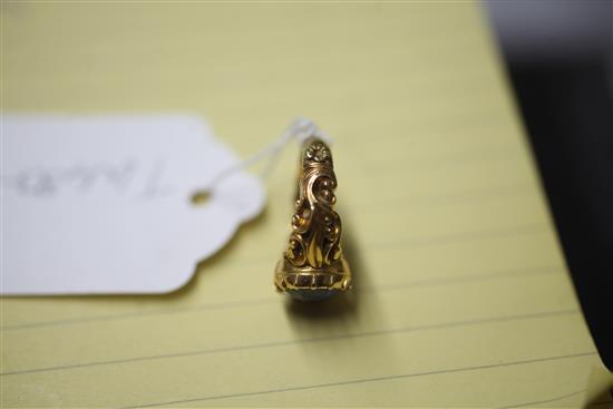 An antique yellow metal ring set with an oval sapphire in scroll-carved and pierced mount, size O.